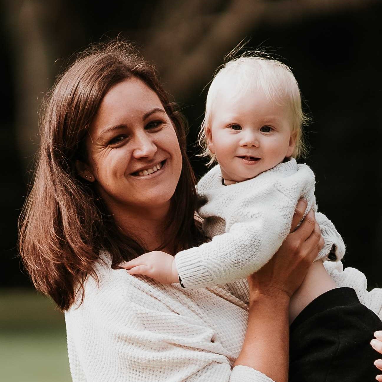 Woman looking happy, holding a small boy